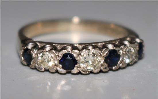 An 18ct white gold, diamond and sapphire half hoop ring, size N.
